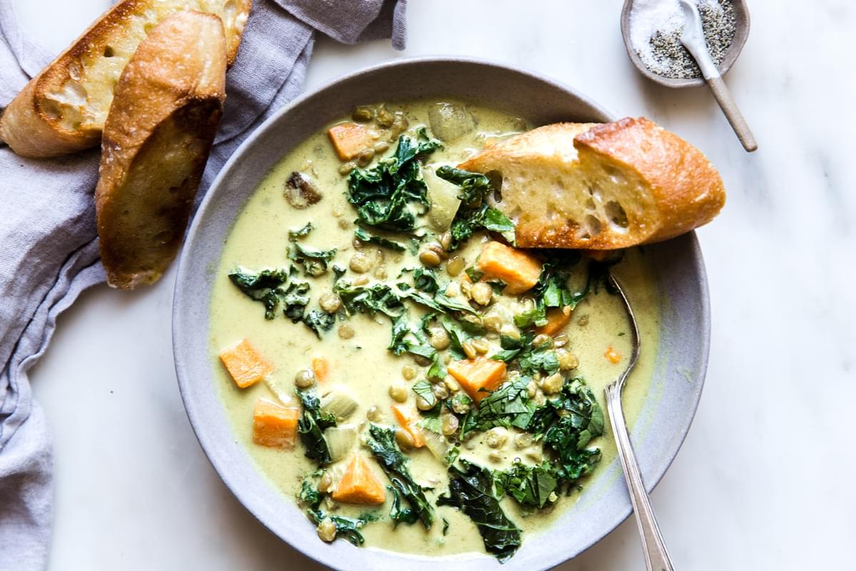 bowl of coconut curry lentil soup with toasted bread