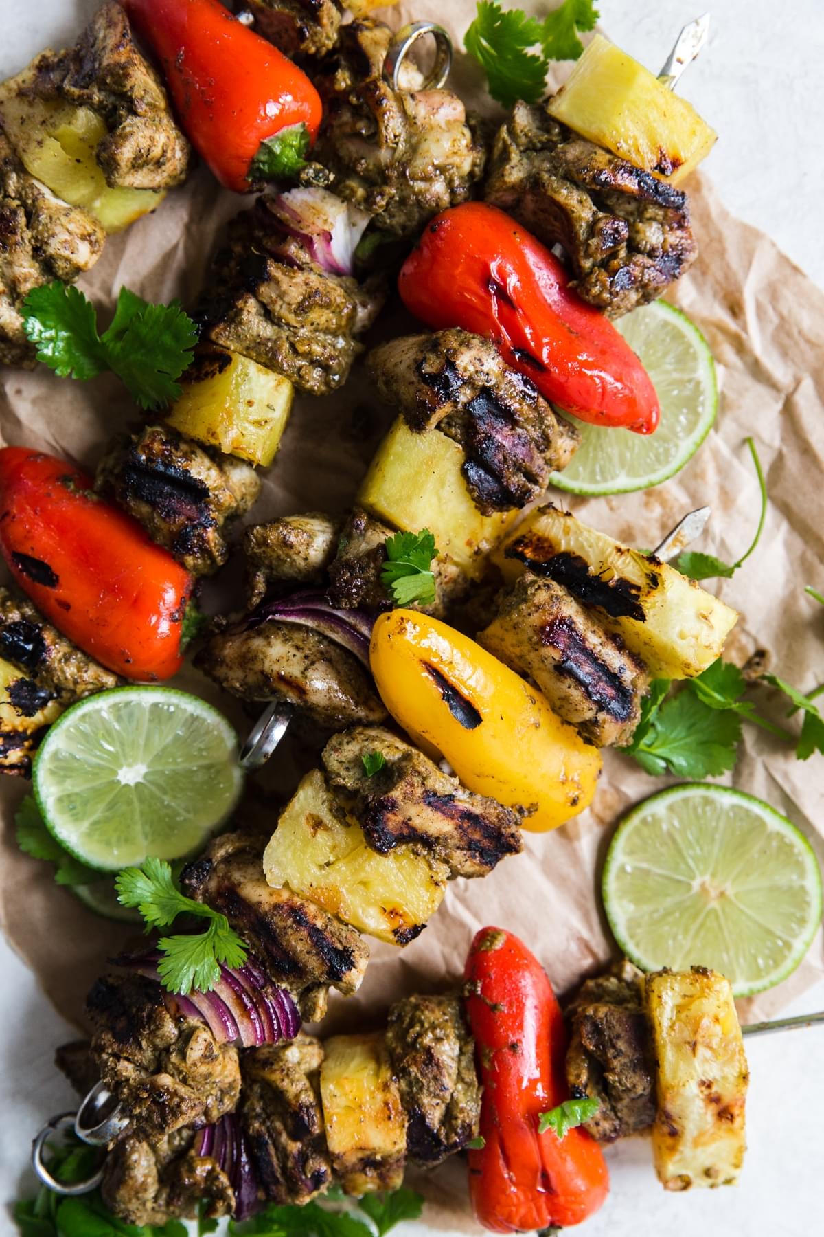 grilled jerk chicken kebabs with pineapple, bell peppers, red onions, lime and cilantro