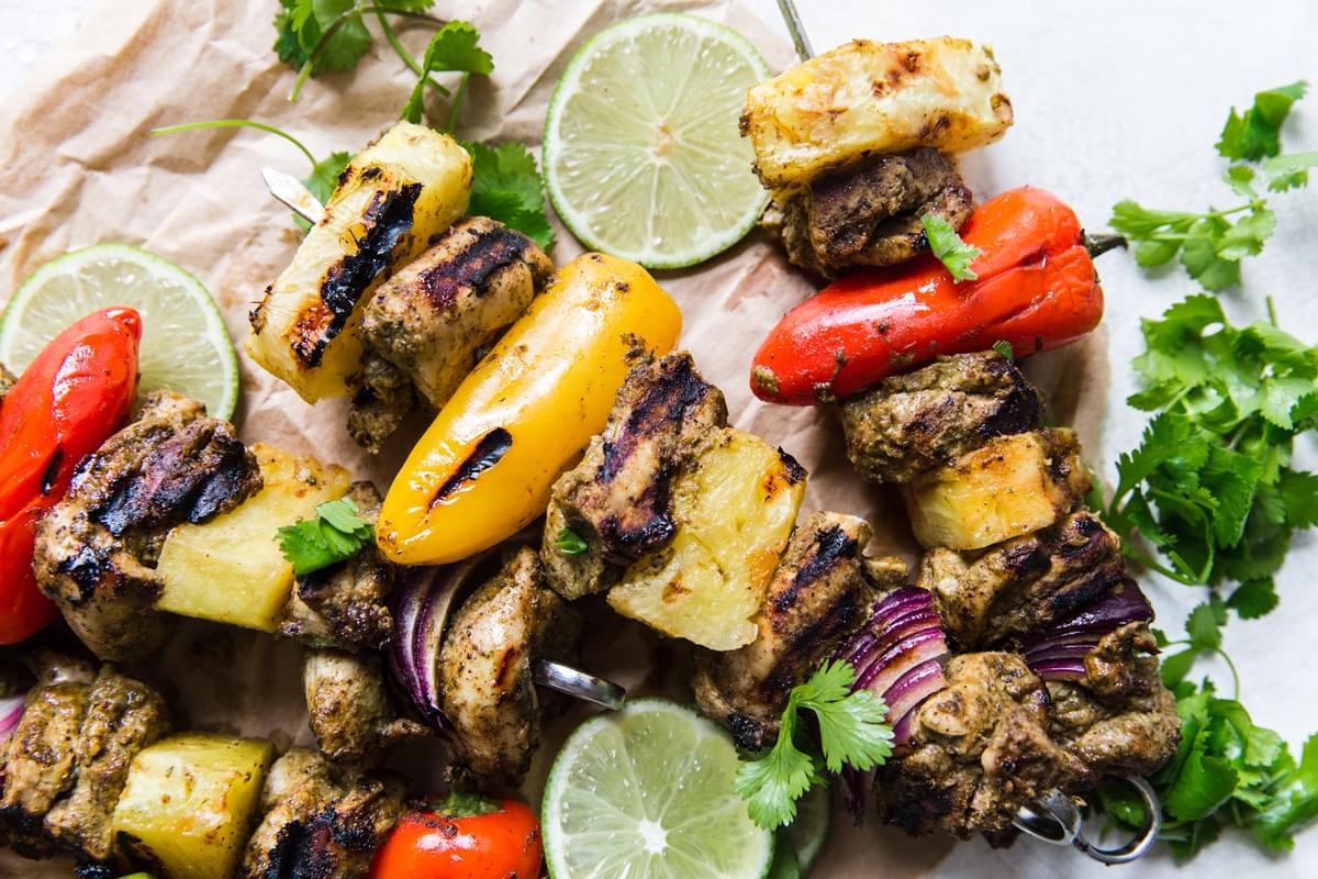 grilled jerk chicken kebabs with pineapple, bell peppers, red onions, lime and cilantro