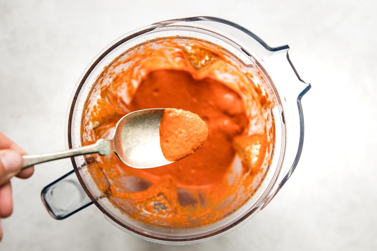 harissa chicken marinade in a blender and on a spoon