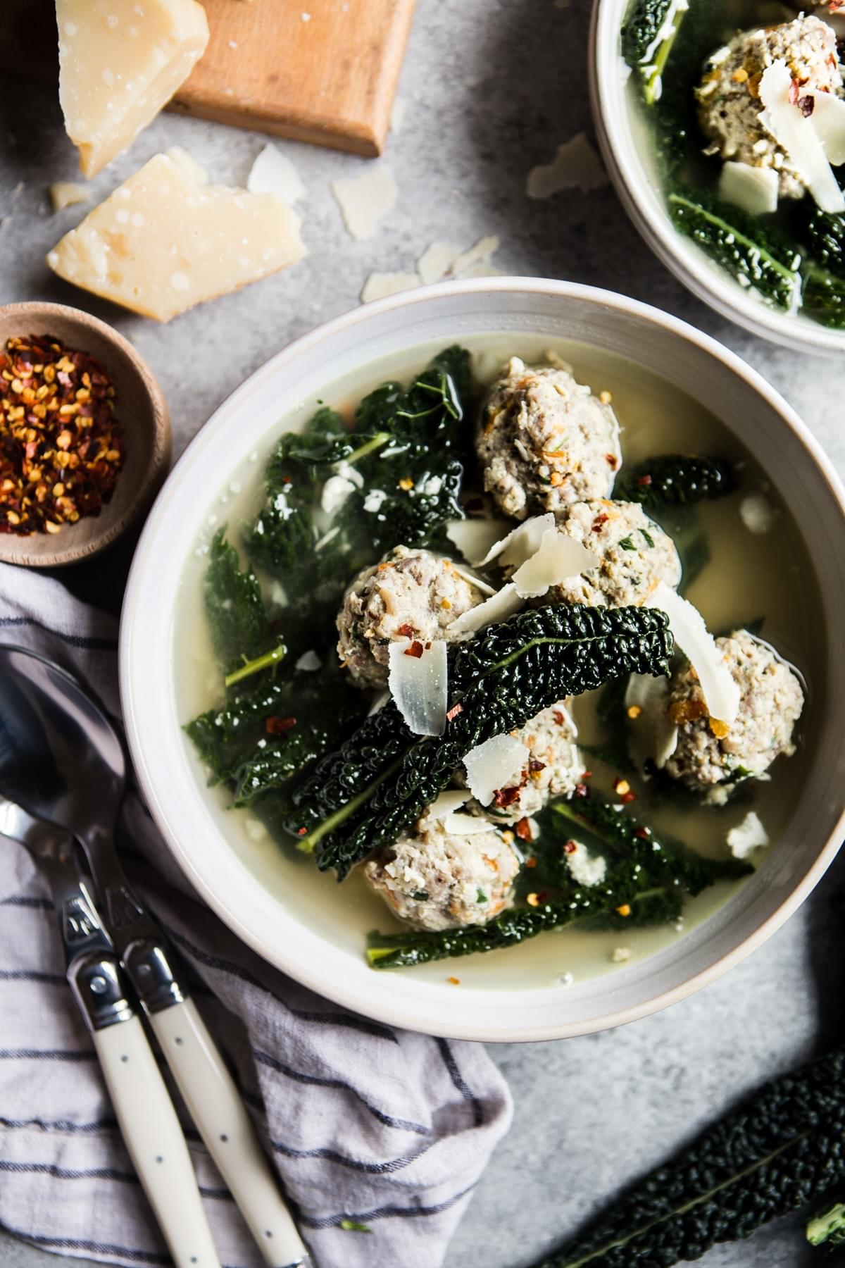 Homemade Italian wedding soup in a bowl with kale and meatballs