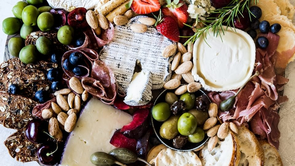 how to build the perfect these board with olives and crackers, nuts and fruit