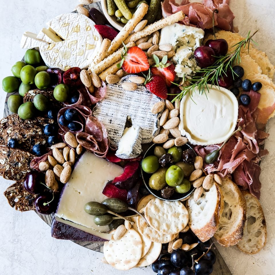 how to build the perfect these board with olives and crackers, nuts and fruit