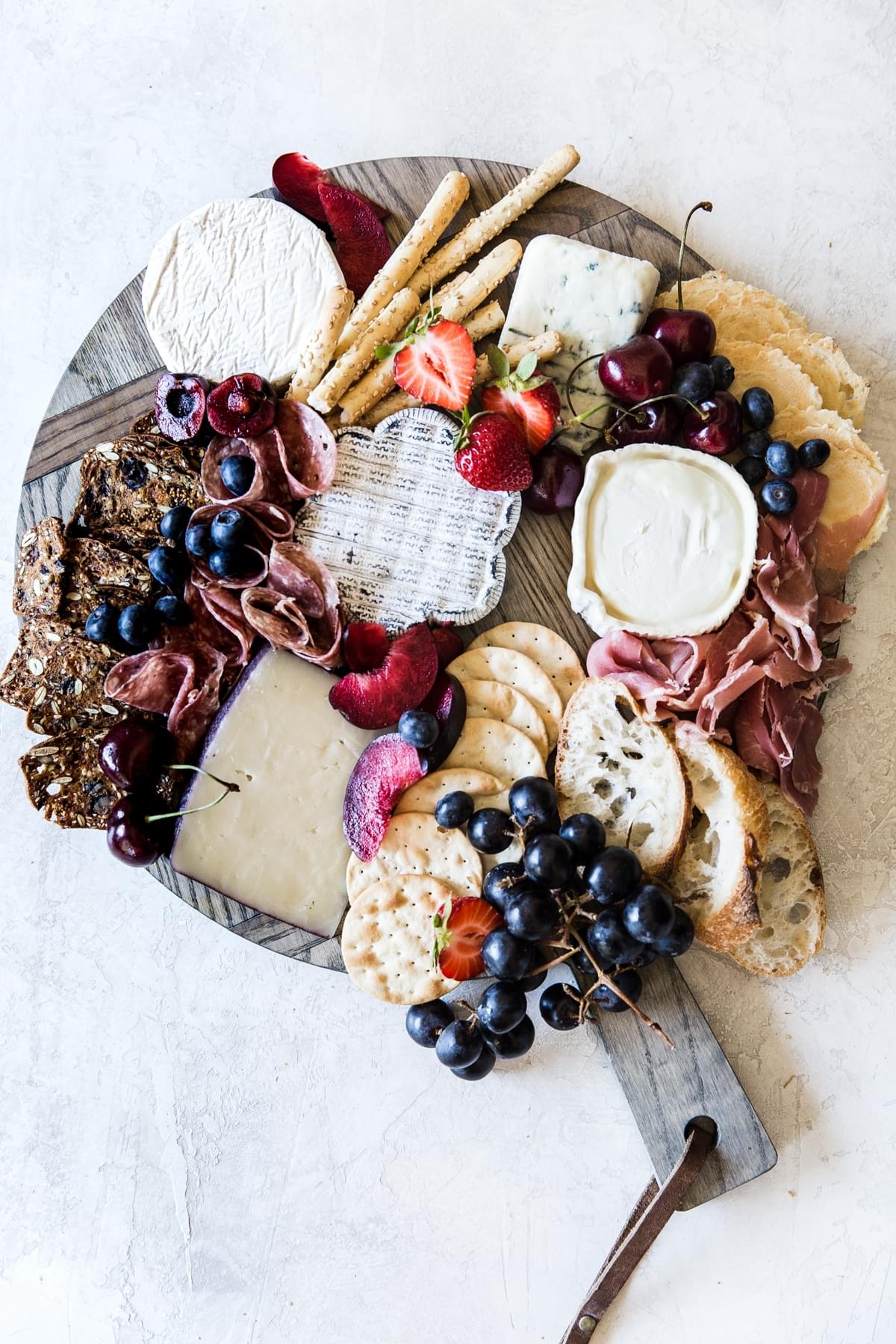 how to build a cheese board with crackers meats and fruit