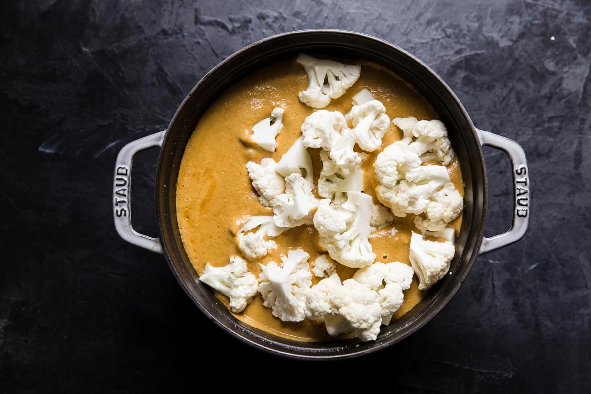 coconut curry with raw cauliflower in a pot