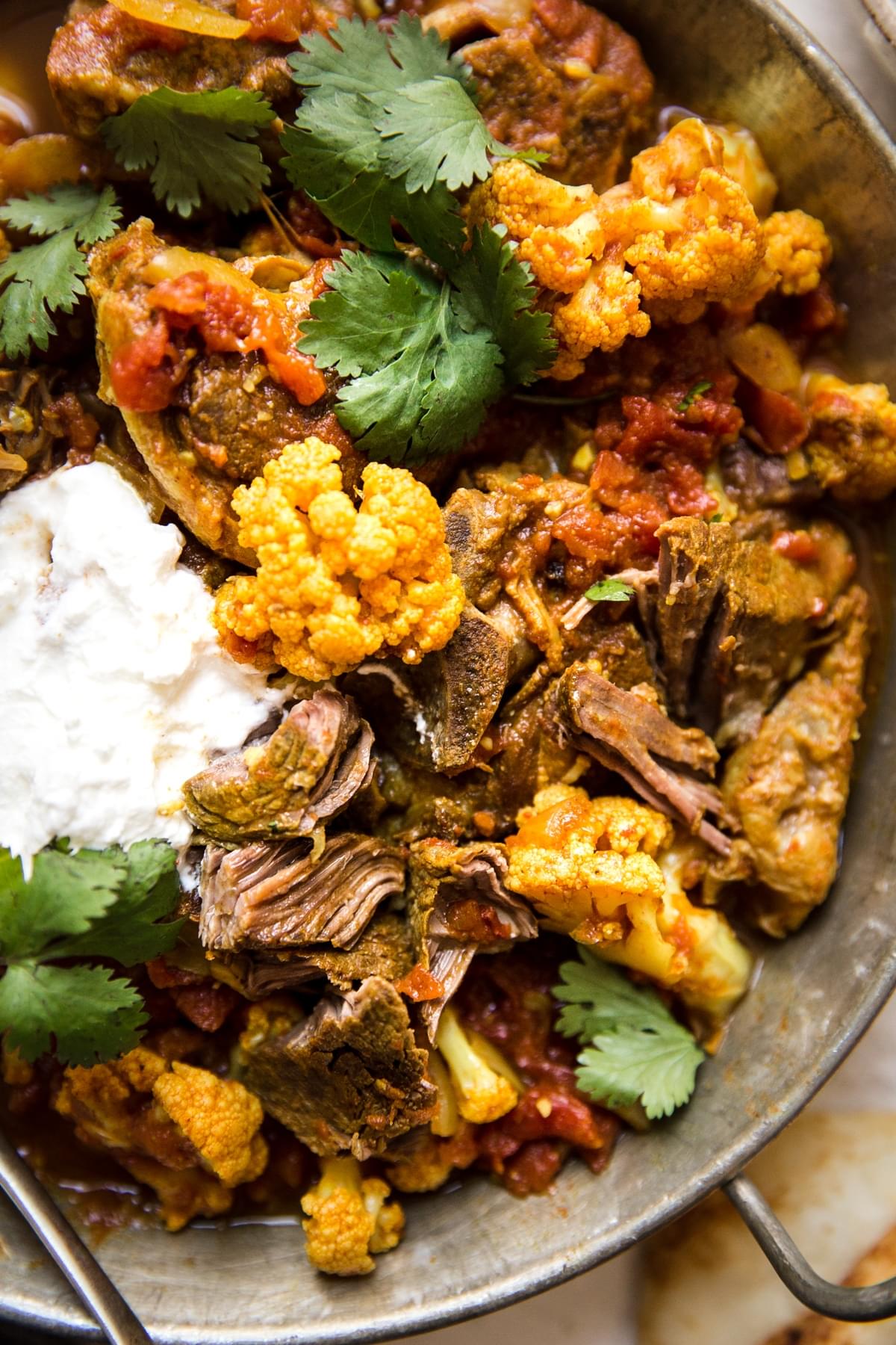 Indian Lamb Curry stew With Cauliflower with cilantro, tomatoes and yogurt.