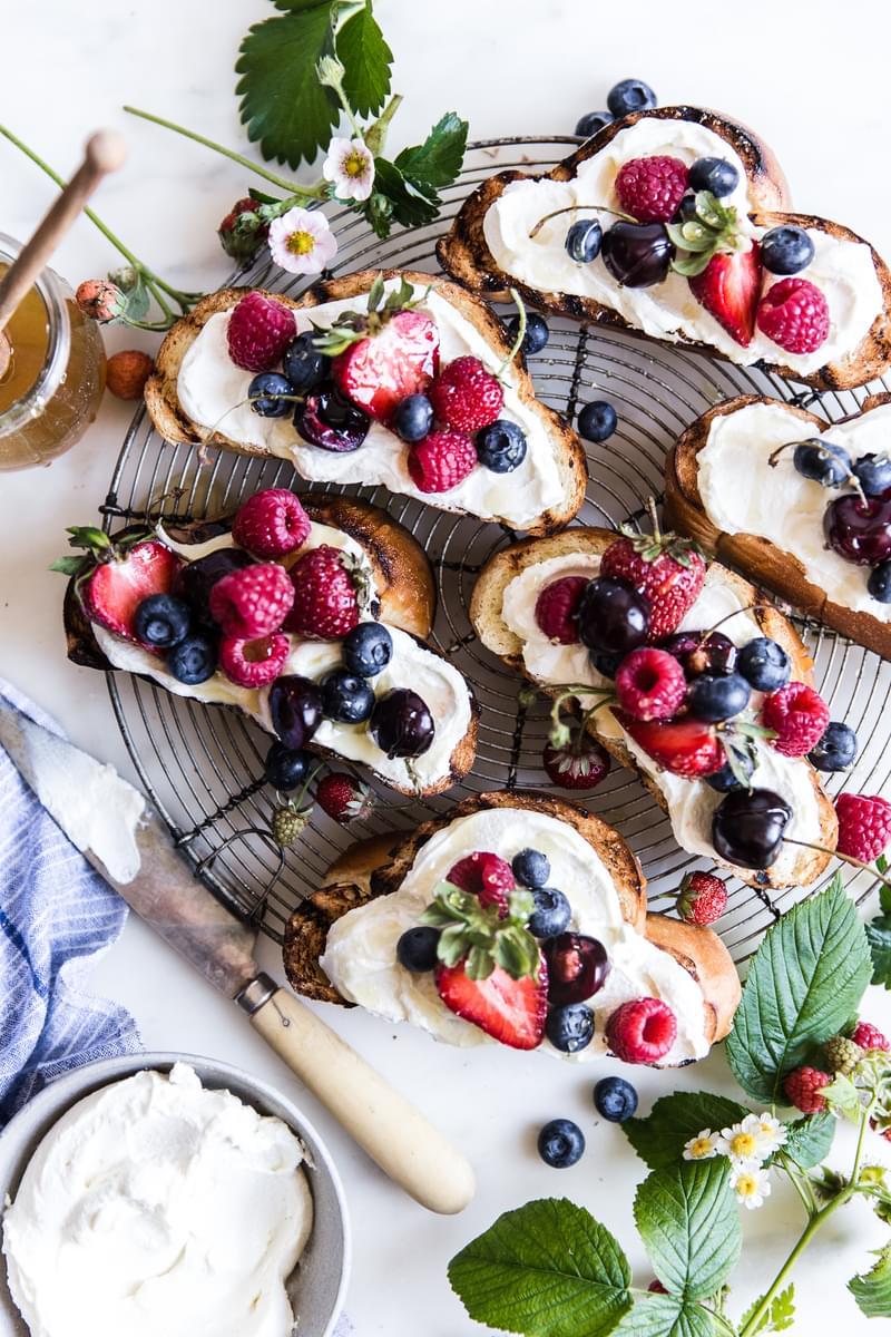 Toasted challah bread with a yogurt mascarpone spread, fresh berries, drizzled with honey.