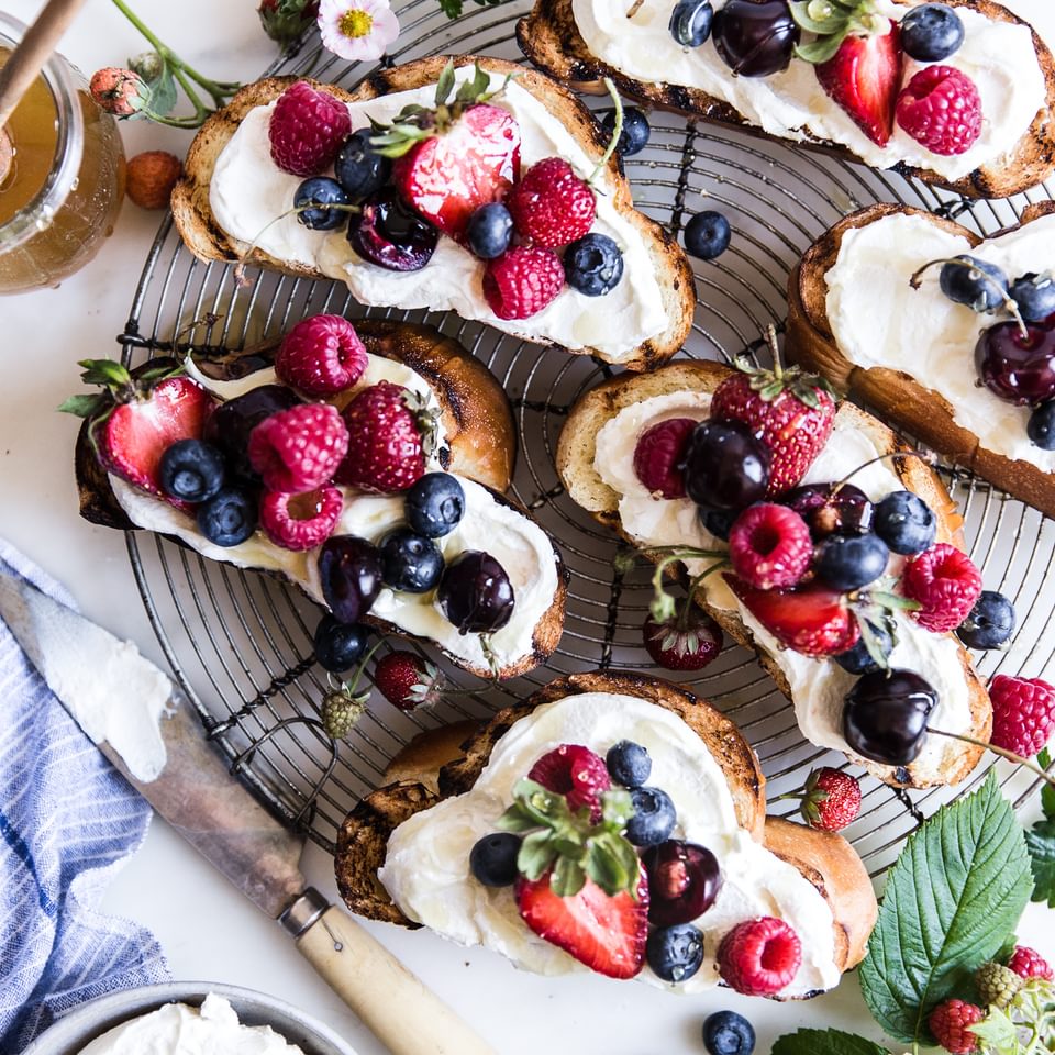 Challah bread with honey, cherries, strawberries, raspberries, blueberries, mascarpone, greek yogurt. Berry bruschetta