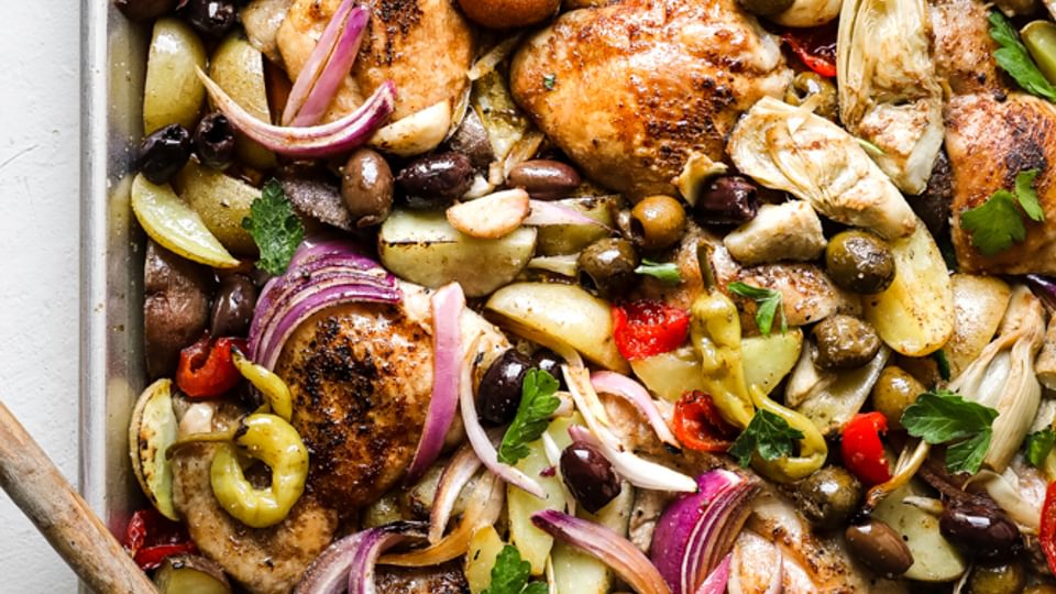 sheet pan chicken dinner made with ingredients found at the olive bar with potatoes.