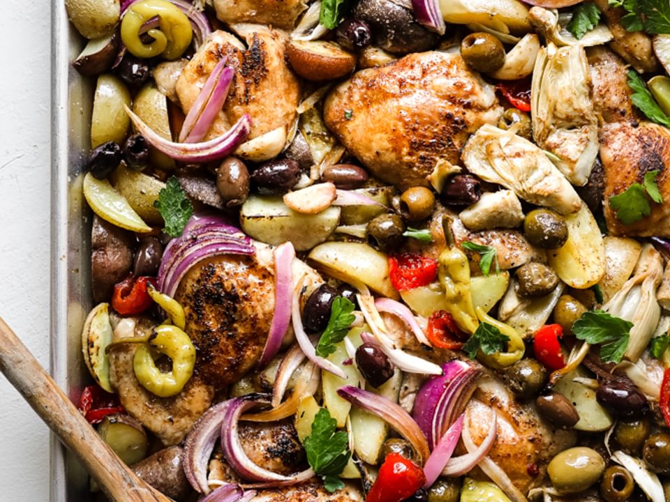 sheet pan chicken dinner made with ingredients found at the olive bar with potatoes.