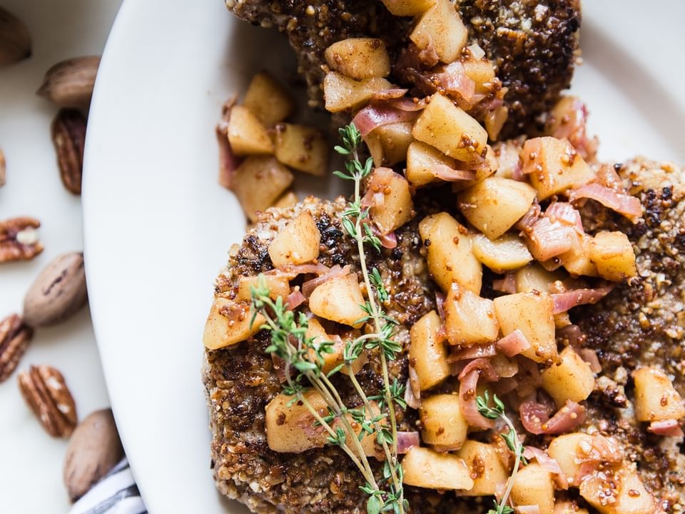 Pecan Crusted Pork Chops With Apple Chutney  on a plate