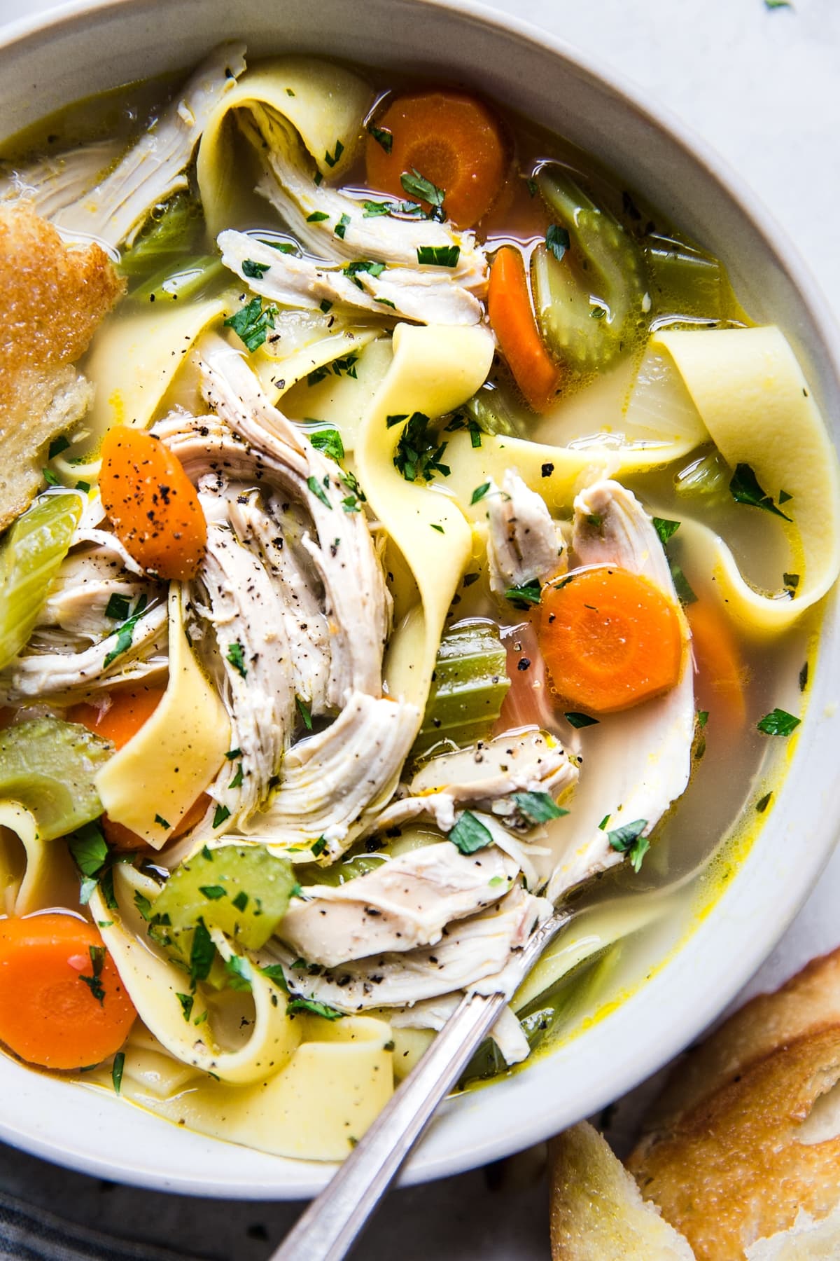 homemade chicken noodle soup in a bowl with a spoon
