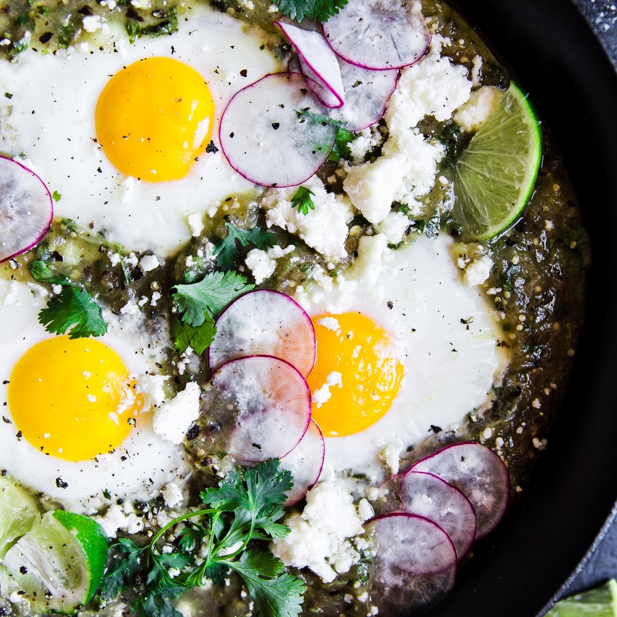 3 eggs baked in salsa verde with radishes and lime and cilantro