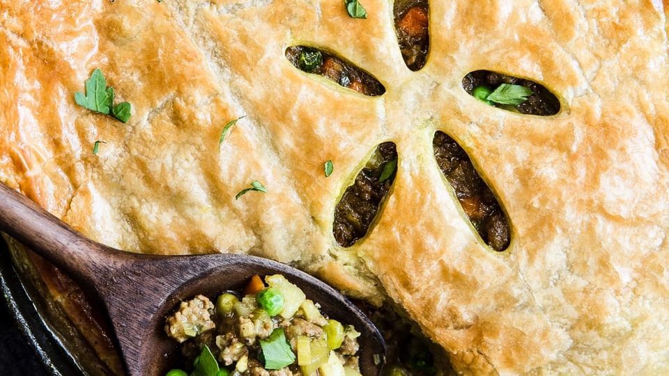 rustic lamb pot pie with curry in a cast iron skillet