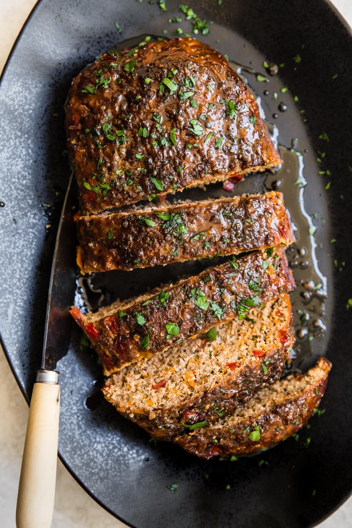 Turkey Quinoa Meatloaf sliced on a black plater