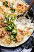 Baked jalapeño popper Macaroni and cheese in a baking dish with a spoon