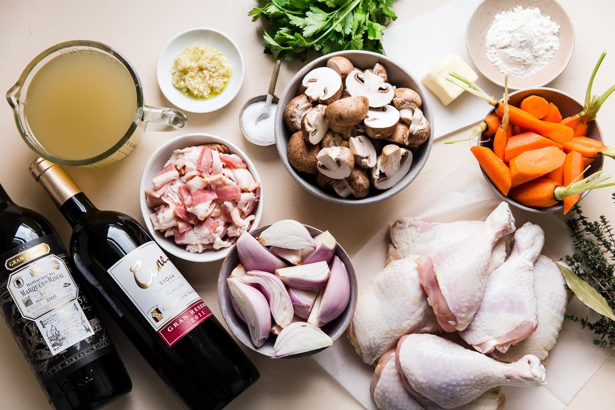 chicken, carrots, mushrooms, wine, garlic, stock and herbs for homemade coq au vin