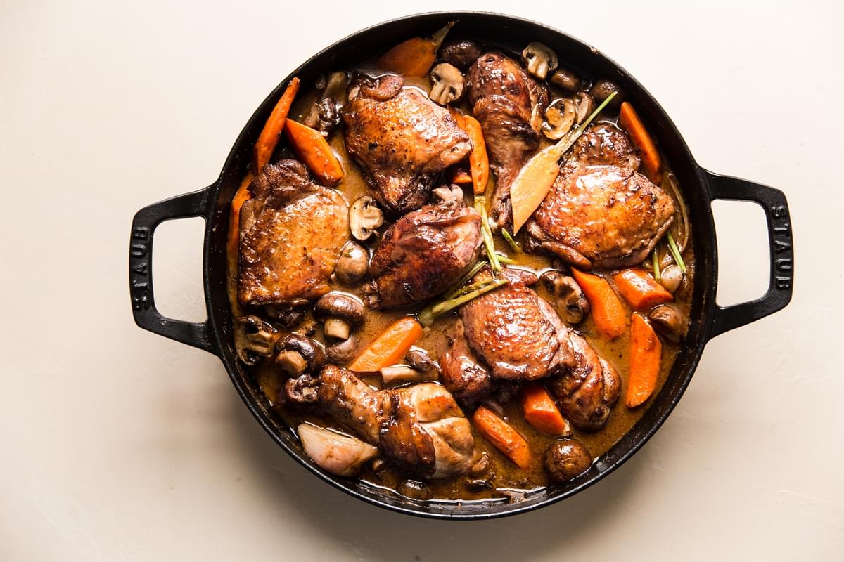 Coq Au Vin with carrots, mushrooms and chicken in a pot