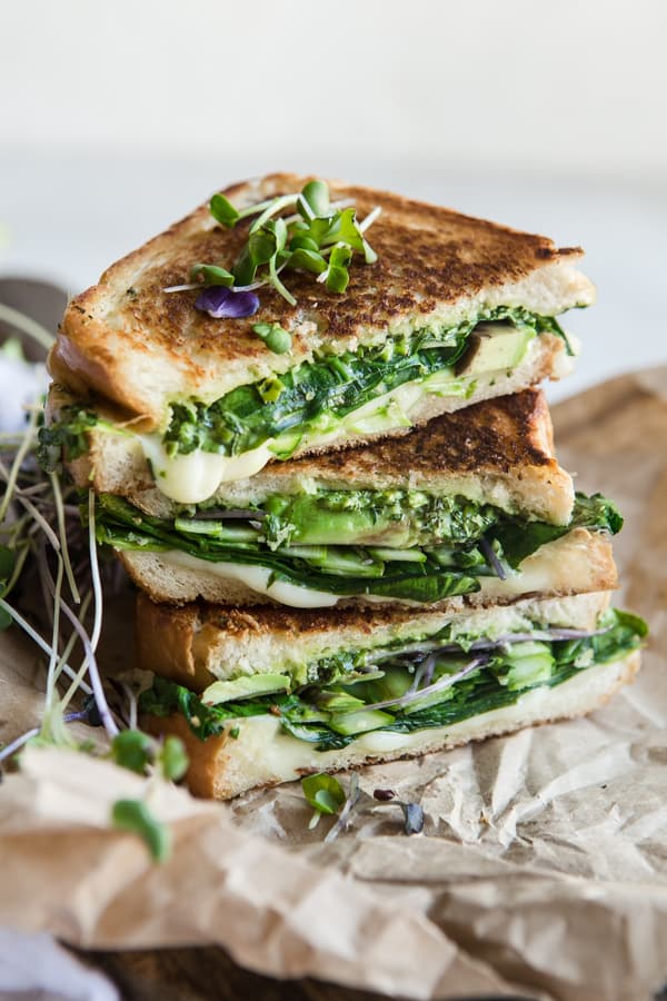 green goddess grilled cheese sandwich with avocado , spinach, asparagus and herbs