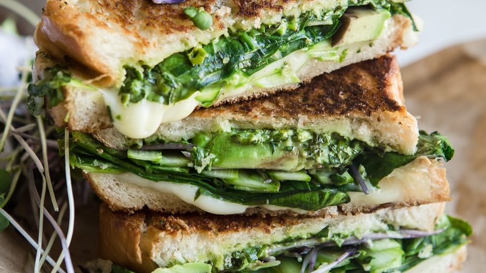green goddess grilled cheese sandwich with avocado , spinach, asparagus and herbs