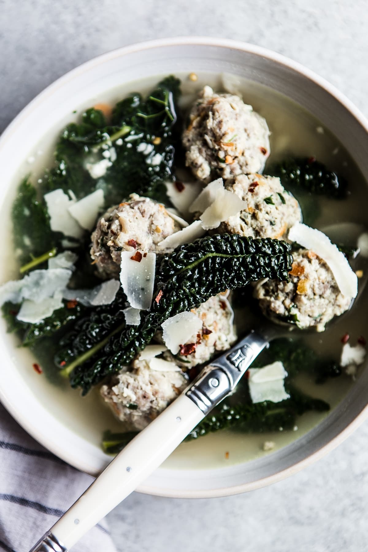 Paleo, whole30 Italian Wedding Soup with meatballs and kale in a bowl