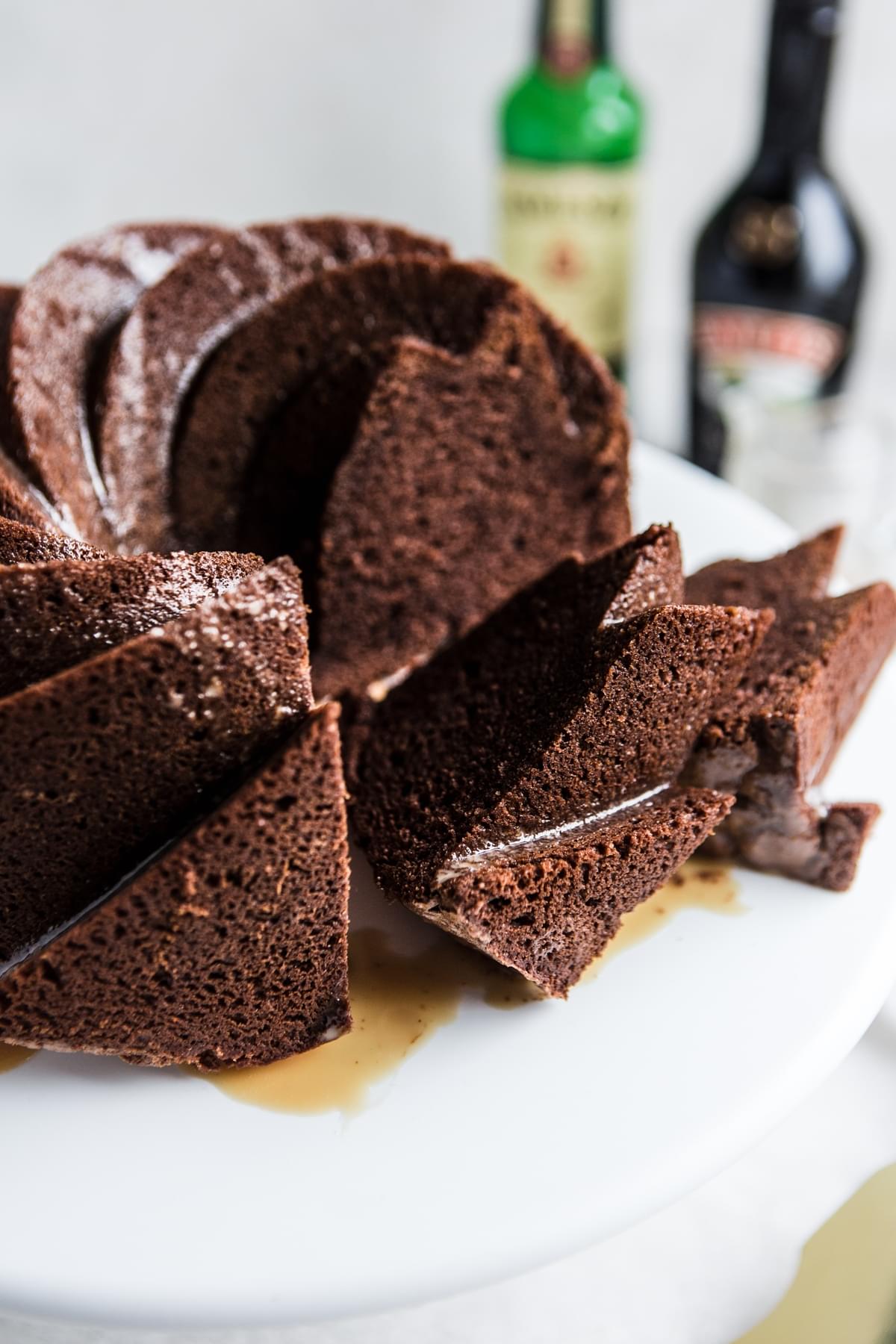 Irish Cream Chocolate Bundt Cake sliced on a cake stand