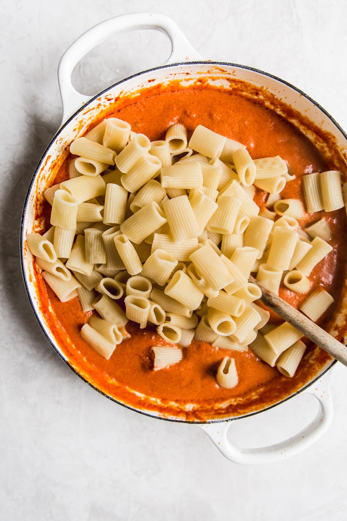 pasta in a pan with tomato cream sauce