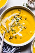 Roasted Butternut Squash Soup With Apples onion and thyme in a bowl with a spoon