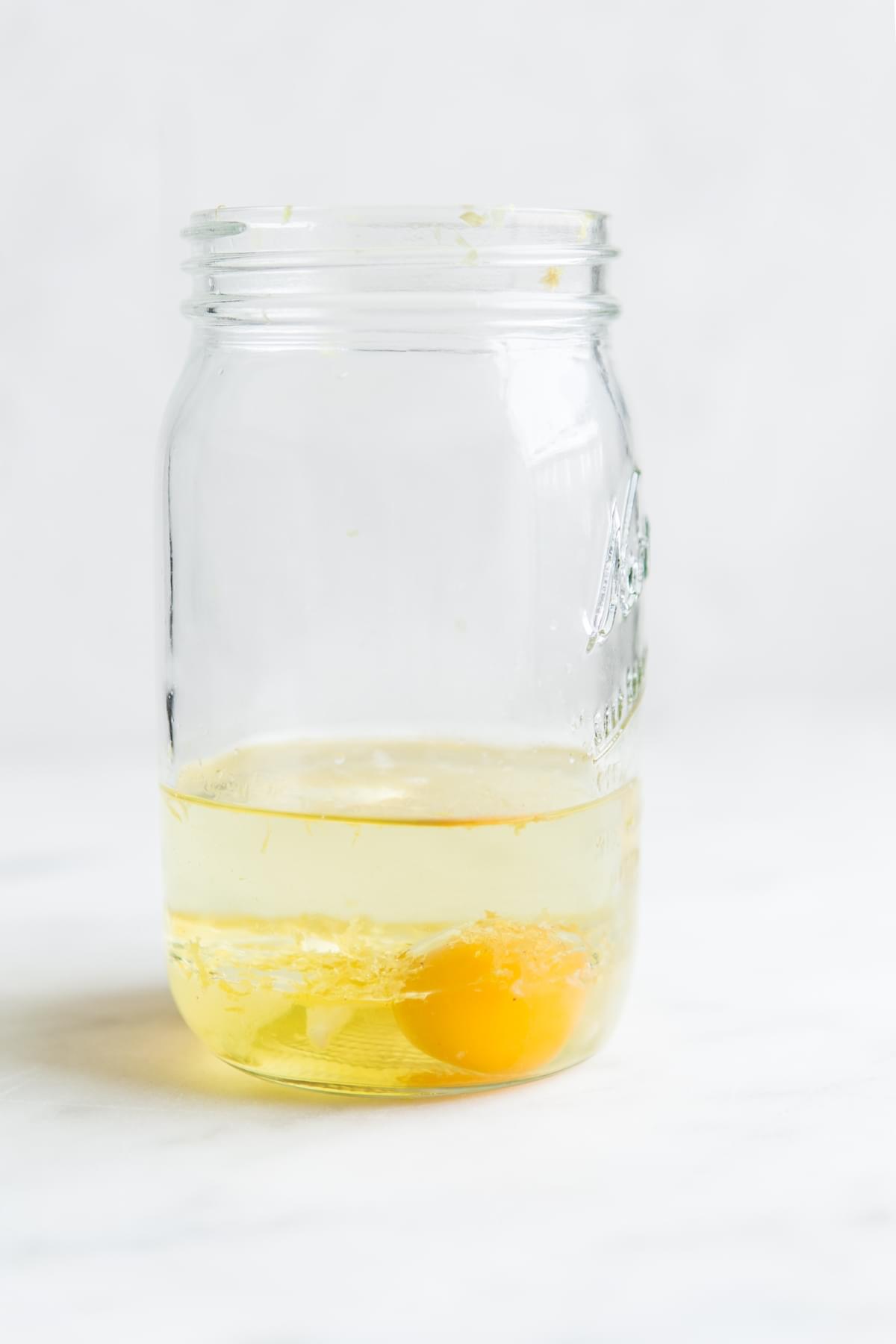 egg and olive oil in a mason jar for homemade aioli