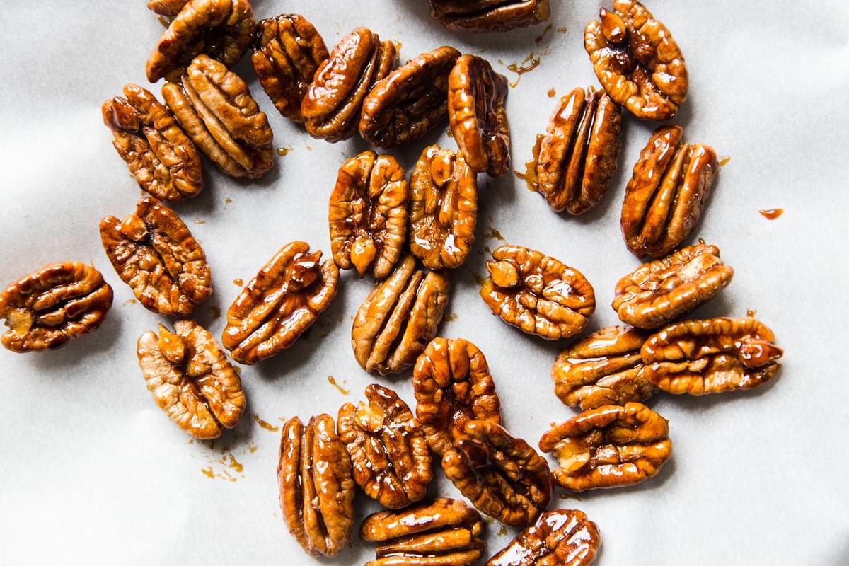 candied spiced pecans on parchment paper