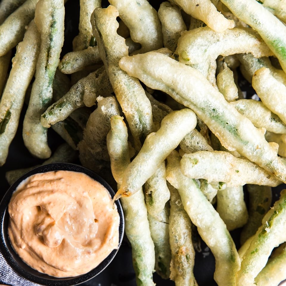 tempura green beans with curry mayonnaise on a platter