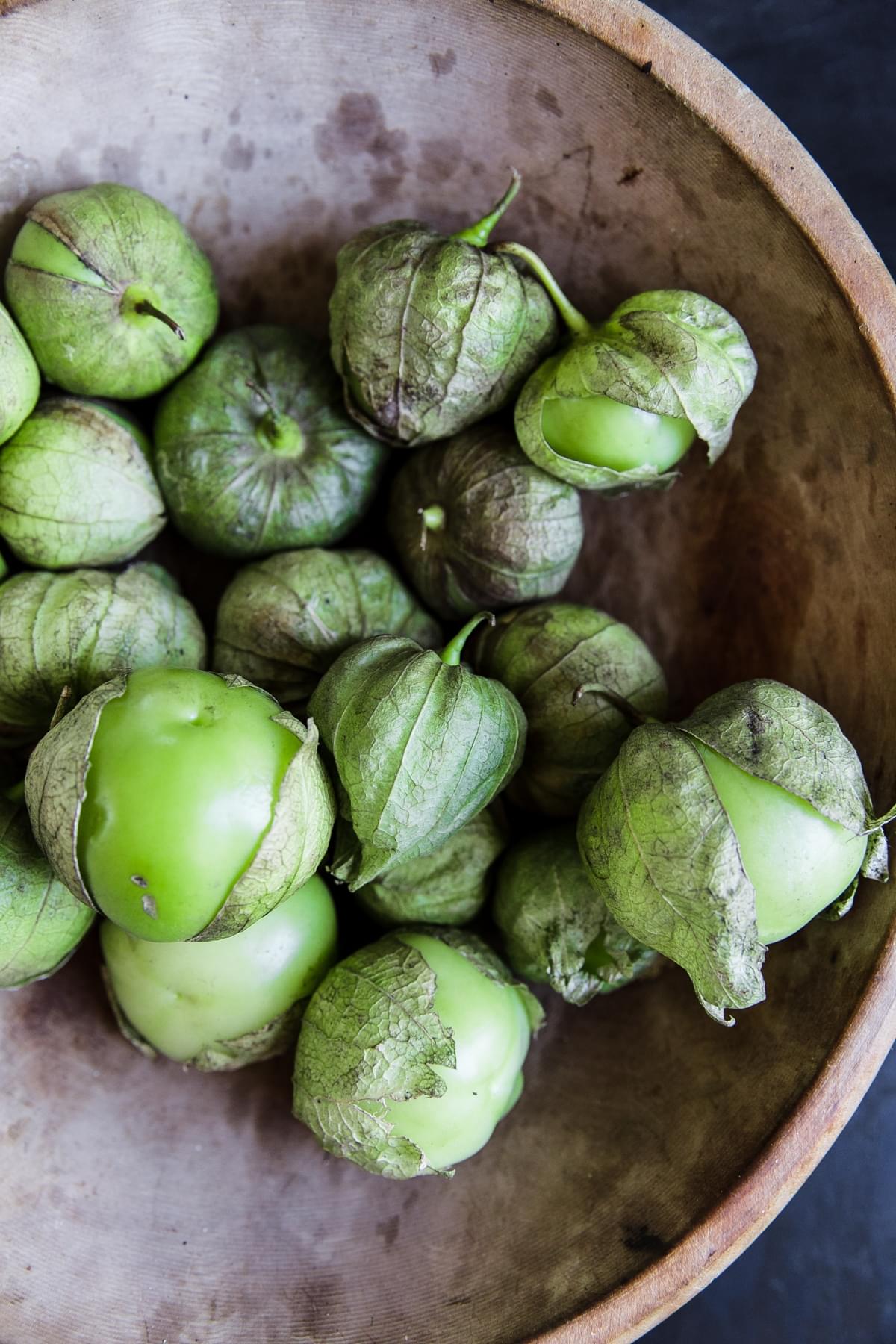 Tomatillos in a bowl for salsa verde