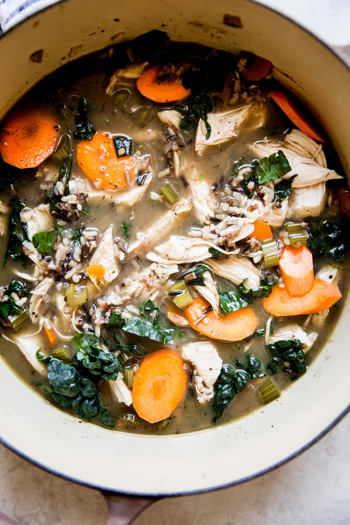 wild rice soup made with turkey carrots, kale, onion and celery