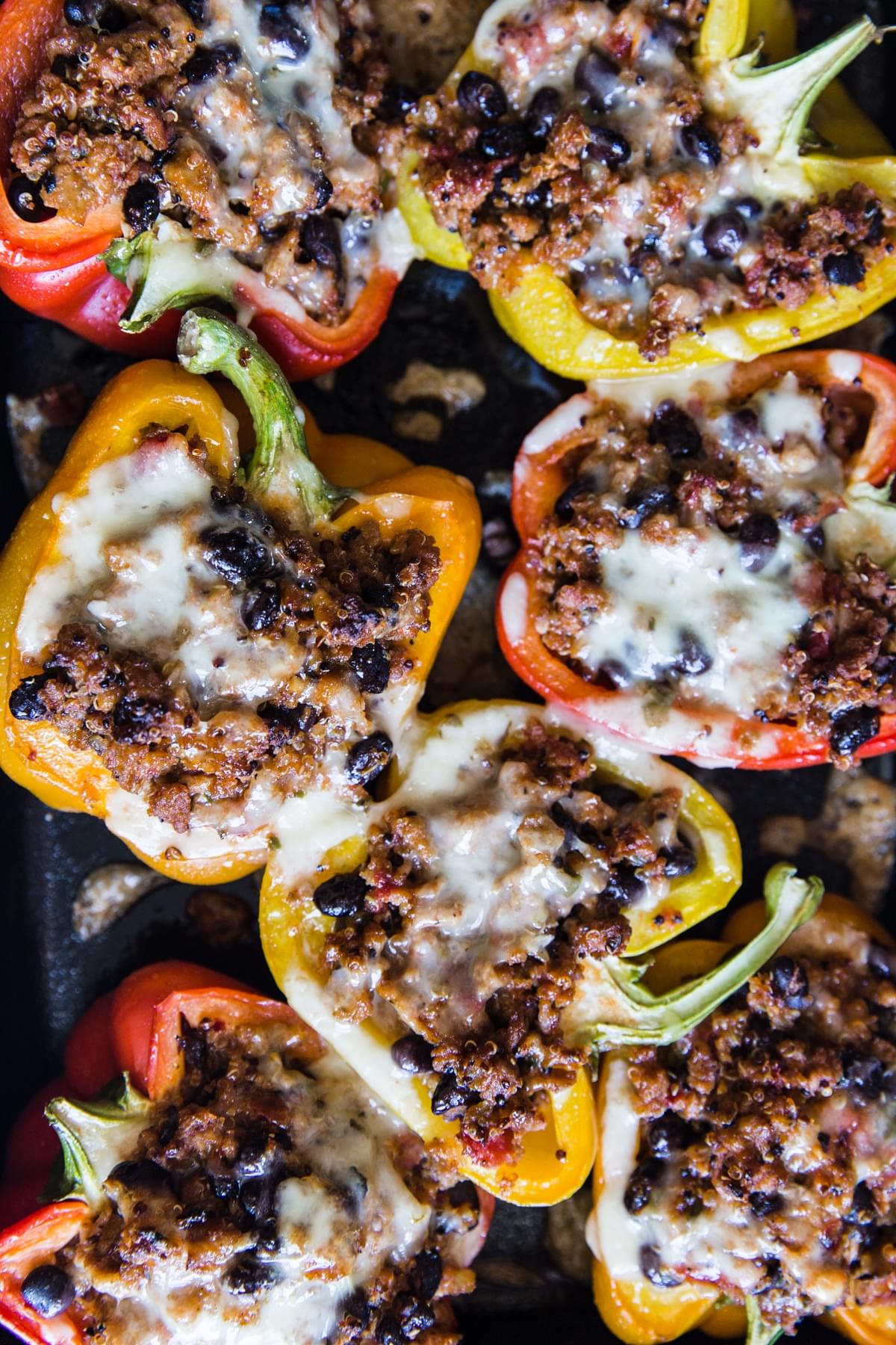 close up of turkey quinoa stuffed bell peppers topped with melted cheese