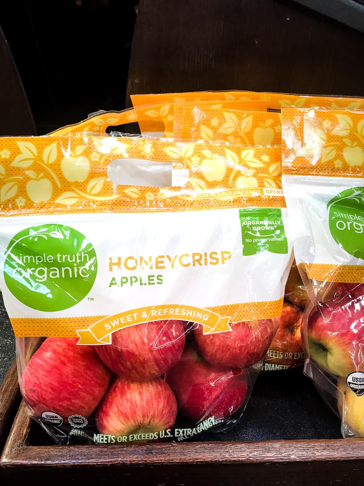bag of simple truth organic honey crisp apples on a store shelf