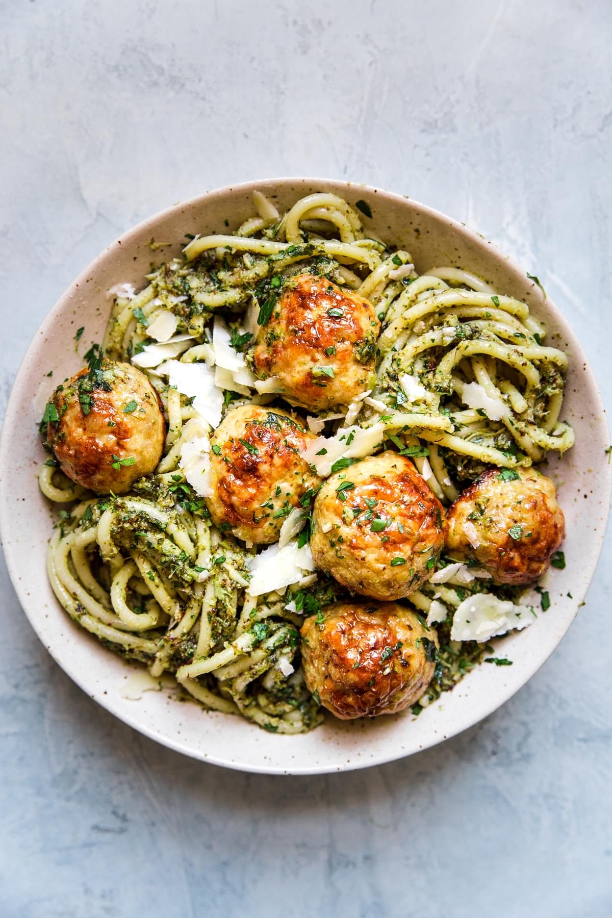 baked chicken meatballs with broccoli pesto pasta in a bowl