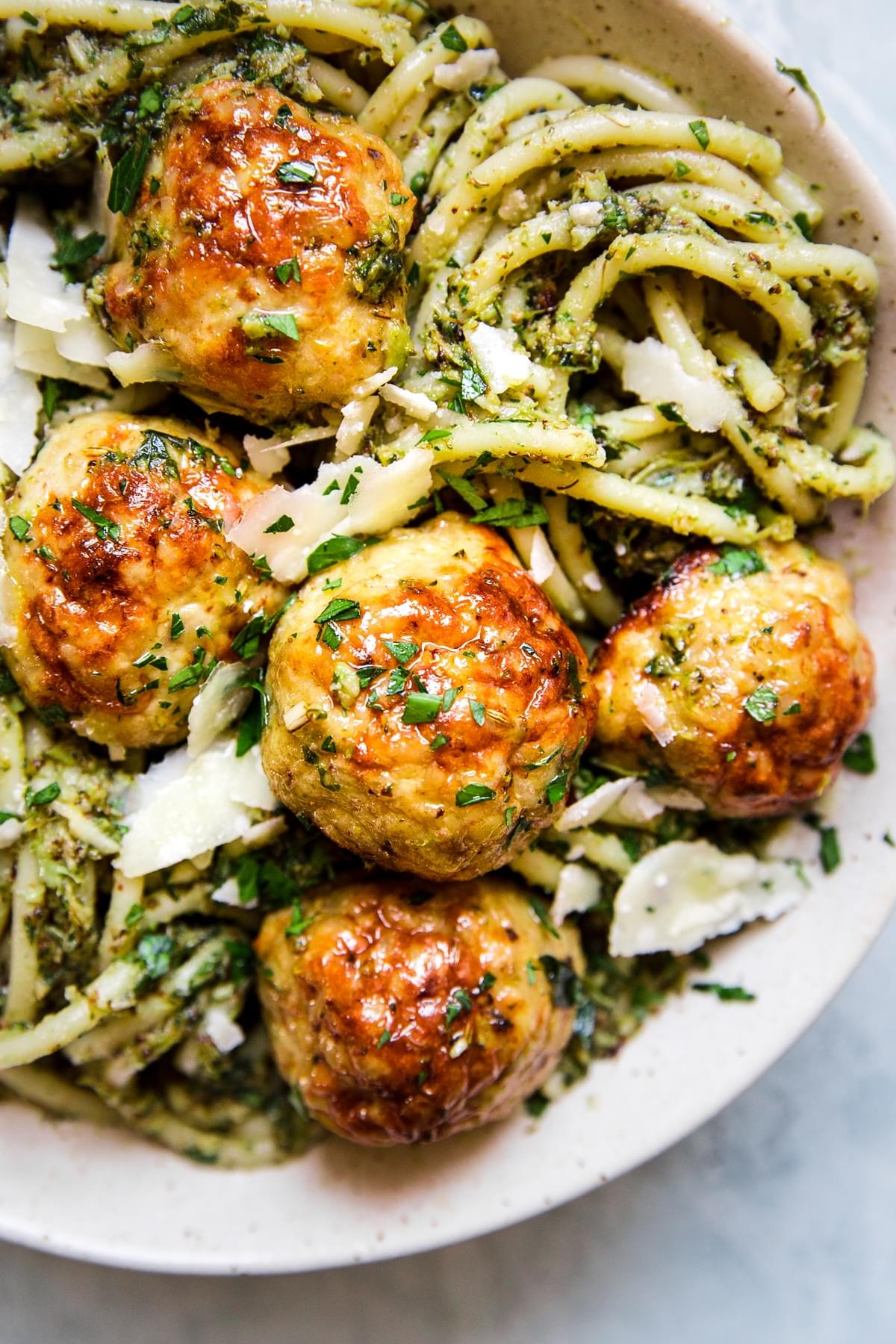 baked chicken meatballs with broccoli pesto pasta in white bowl