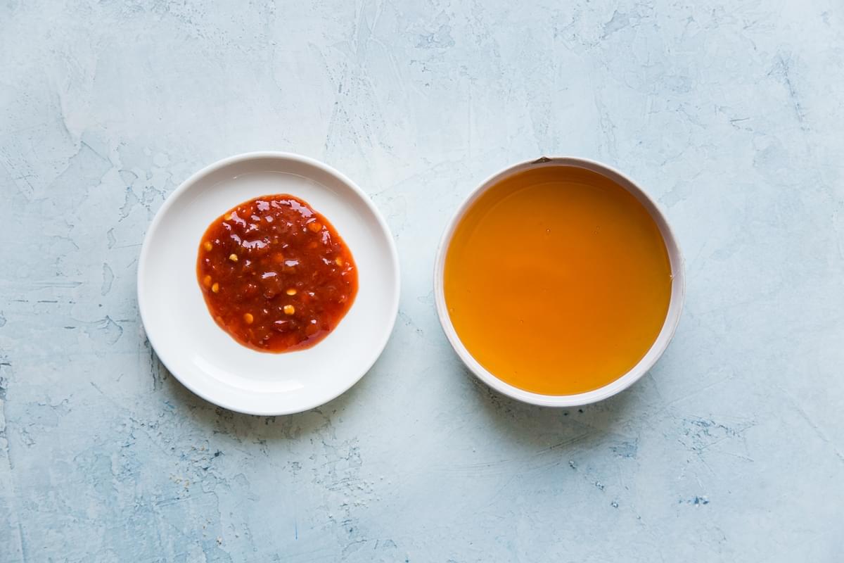 two small bowls filled with honey and chili paste