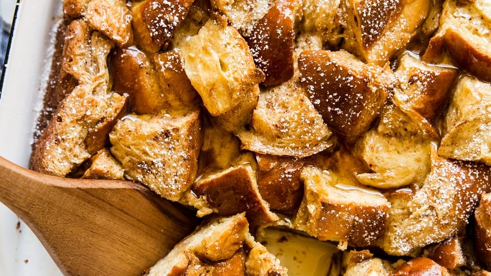 Baked French Toast recipe in a casserole dish with a wooden spoon