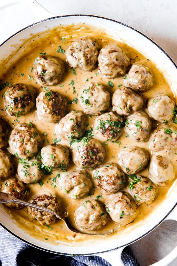 Swedish Meatballs in a pan with a serving spoon