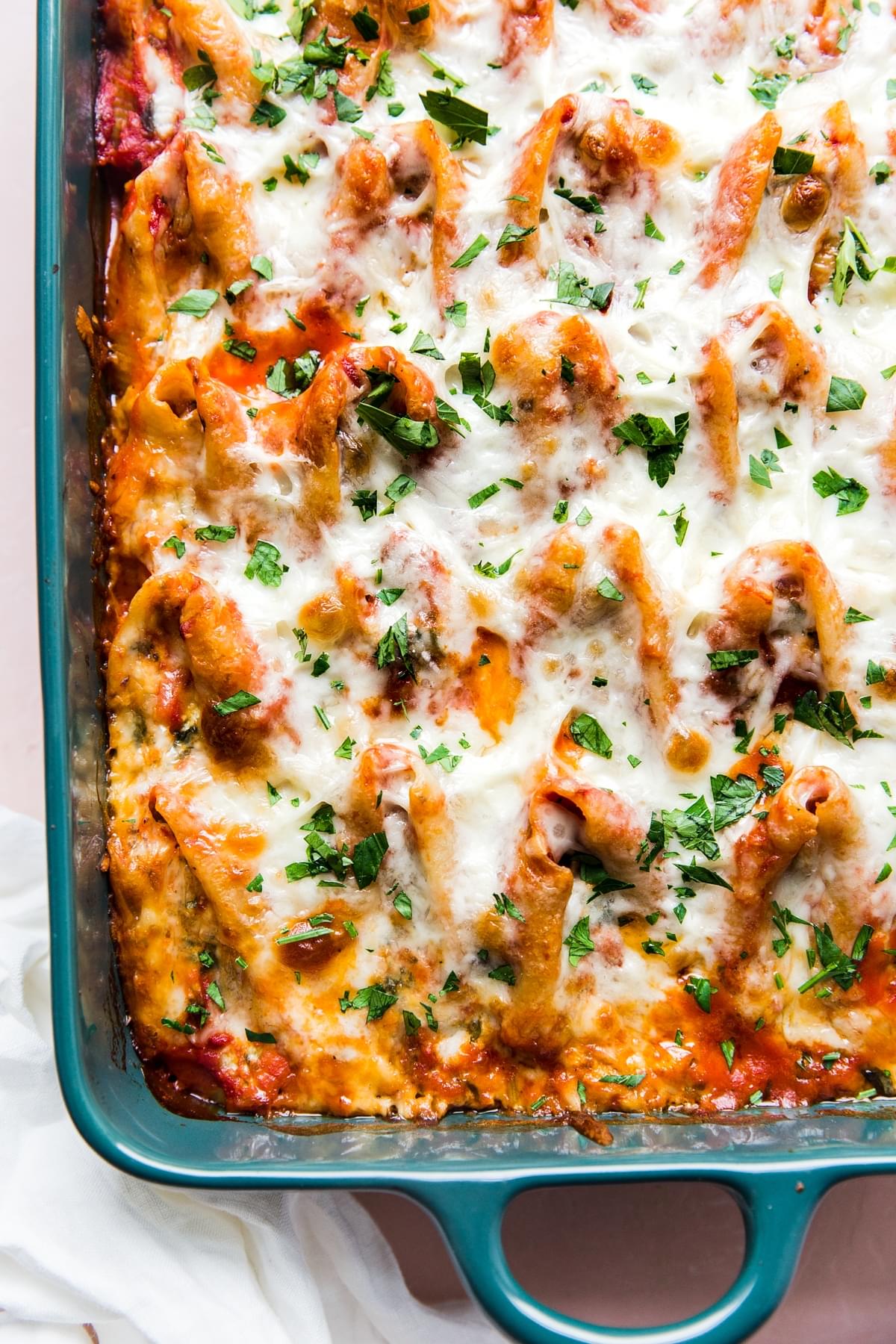 Easy Stuffed Pasta Shells in a pan with tomato sauce and mozzarella