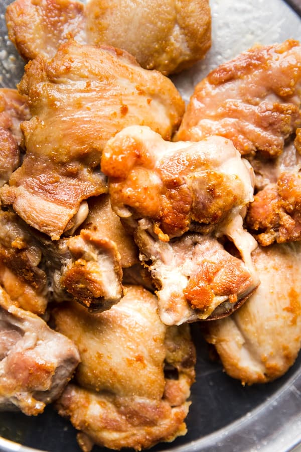pan-fried Boneless Skinless Crispy Chicken Thighs on a plater