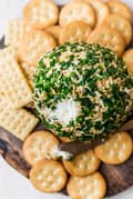 Cheddar And Onion Cheeseball on a platter with crackers