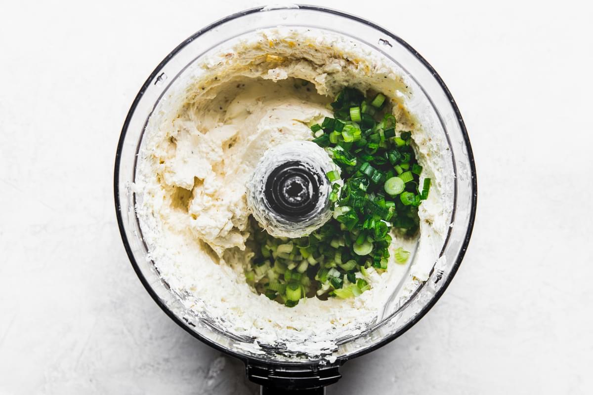 cream cheese, cheddar and spices blended in a food processor green onions