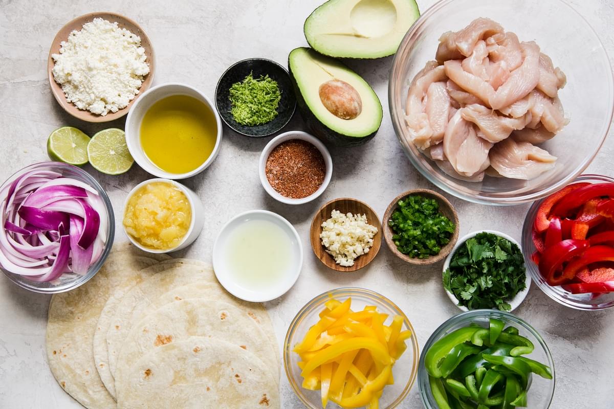ingredients for chicken fajitas in small bowls