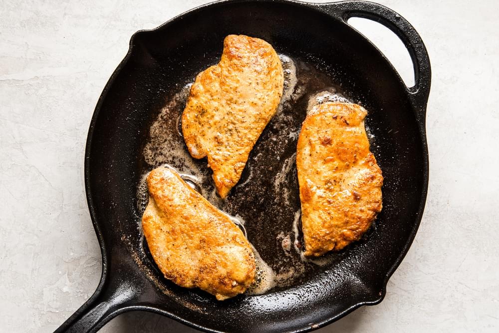 chicken breast dredged in flour and cooked in butter and olive oil in a cast iron skillet