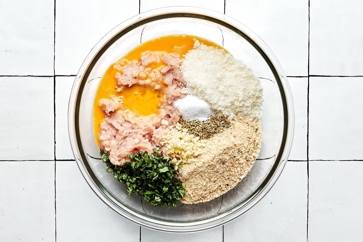 ground chicken, salt, egg, fennel seeds, Parmesan, garlic, basil, and bread crumbs in a glass bowl