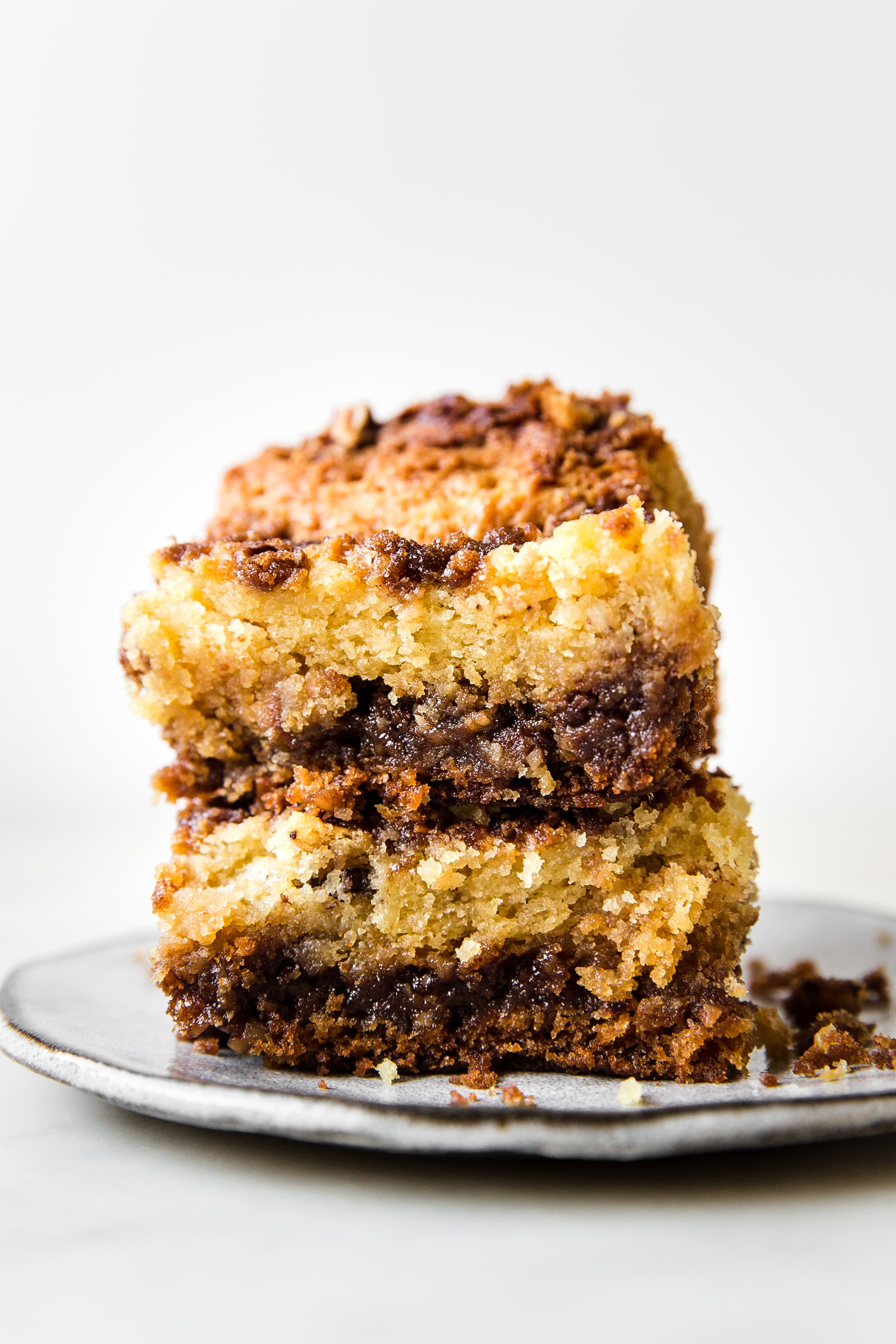 two slices of coffee cake stacked topped with streusel toppings