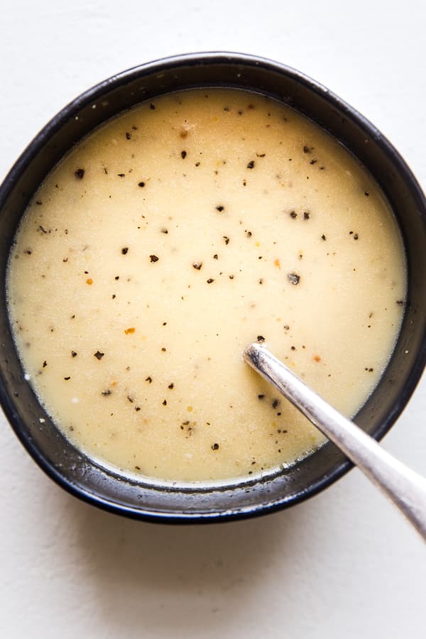 creamy maple salad dressing in a bowl with a spoon