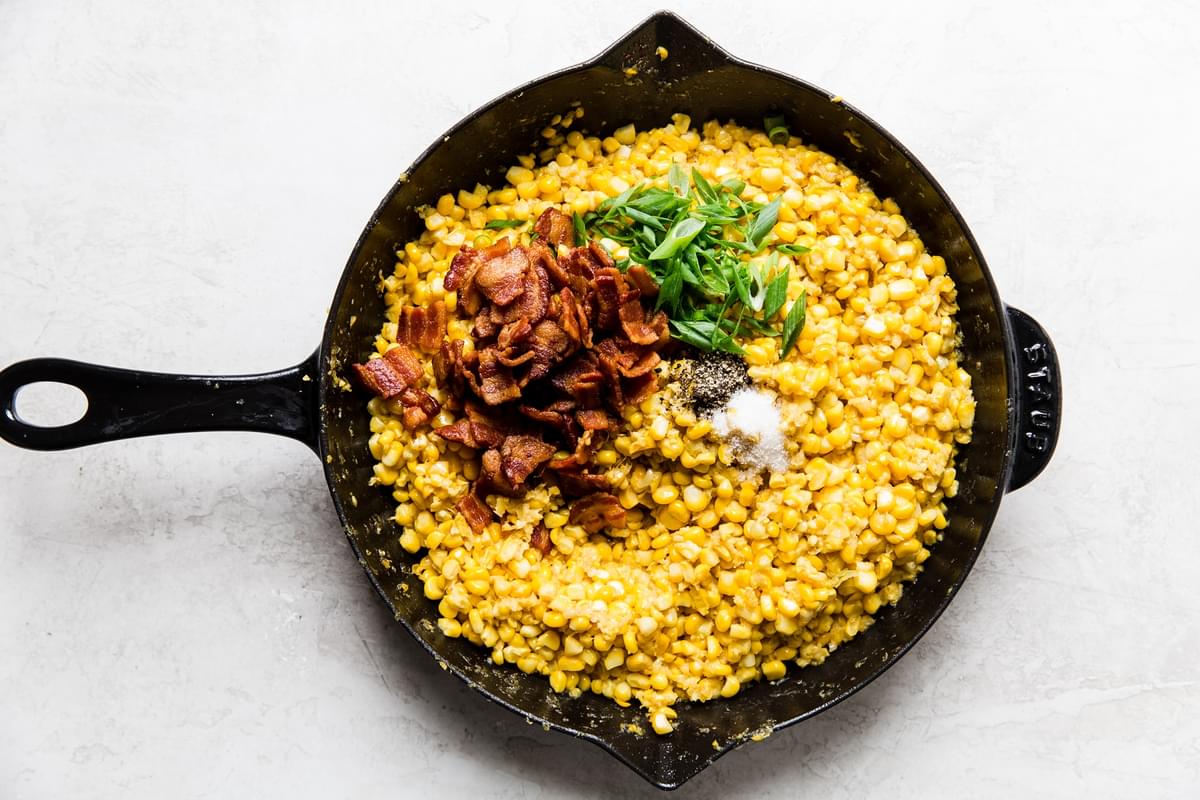 skillet with a little bacon grease, raw corn kernels , salt, pepper, green onions, and bacon